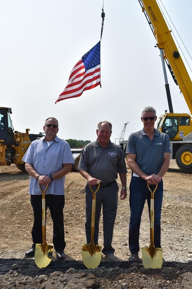 Three men during a groundbreaking ceremony